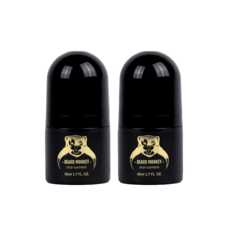 Två svarta cylindriska deodoranter med guldiga detaljer märkta "Beard Monkey Oud/Saffron" och med apa som logotyp.