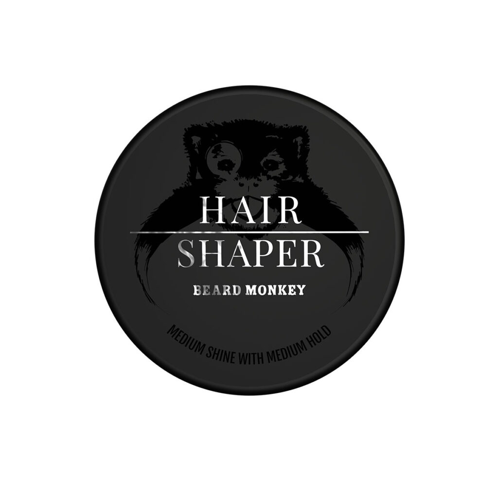 Svart Beard Monkey Hair Shaper burk med glansig svart logga och silvriga detaljer. Hårvax med medium stadga och lätt glans för korta till medellånga frisyrer.