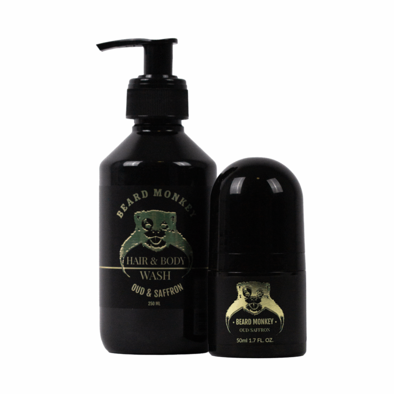 Två produkter från Beard Monkey i doften Oud/Saffron – en svart pumpflaska med Hair & Body Wash (250 ml) och en matchande svart deodorantroll-on (50 ml), båda med guldtryckt logotyp och etikett.